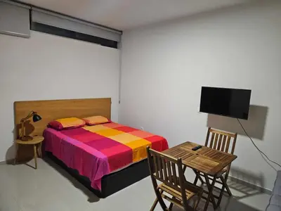 a bedroom with a bed and a table and a tv at Sheila Apartment in Espargos