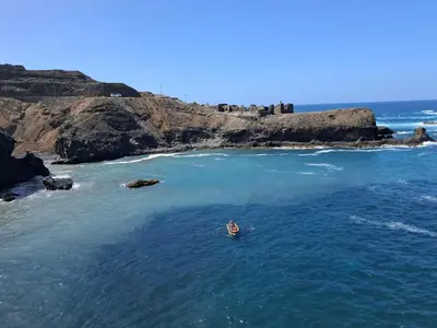 a person in a boat in the ocean at Sinagoga Guesthouse in Ribeira Grande