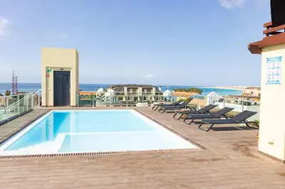 a swimming pool on the roof of a building at 1 Bedroom - 150m from the Beach - Pool in Santa Maria
