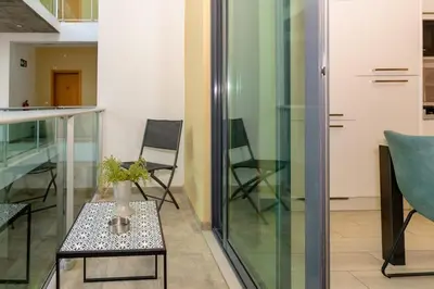 a room with a table with a vase on it at 1 Bedroom - 150m from the Beach - Pool in Santa Maria