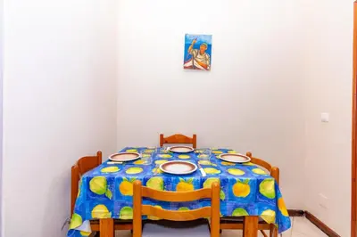 a dining room table with a blue and yellow table cloth at T1 - 800m from the beach - located in the city center in Santa Maria
