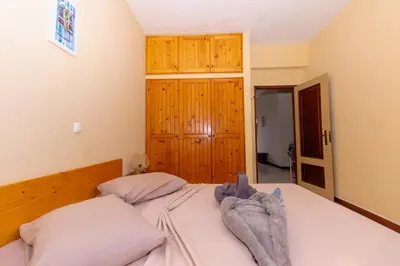 a bedroom with a bed with two pillows at T1 - 800m from the beach - located in the city center in Santa Maria