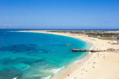 an aerial view of a beach with people and boats at Sal & Mar in Santa Maria