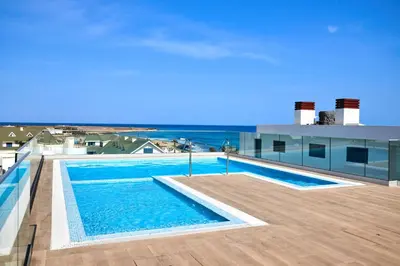a swimming pool on the roof of a building at Sal & Mar in Santa Maria