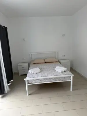 a bedroom with a bed with two towels on it at MeloMar Rooms in Ponta do Sol