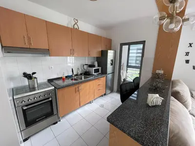 a kitchen with a sink and a stove top oven at Dormir à Praia Cap vert autour de l'aéroport in Praia
