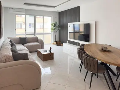 a living room with a couch and a table at 3 bdr cozy apt, Exterior POOL , Cidadela - LCGR in Praia