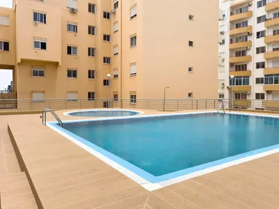 a swimming pool in front of a building at 3 bdr cozy apt, Exterior POOL , Cidadela - LCGR in Praia