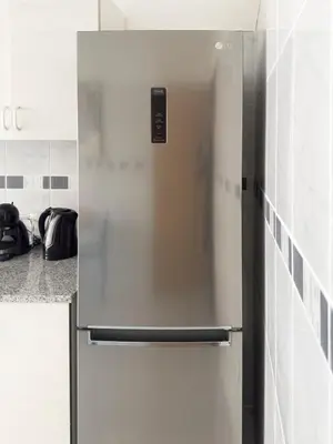 a stainless steel refrigerator in a kitchen at 3 bdr cozy apt, Exterior POOL , Cidadela - LCGR in Praia