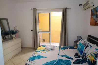 a bedroom with a bed and a sliding glass door at 1 bedroom apartment with sofa bed 4 min walk from the beach in Santa Maria