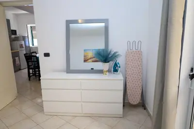 a tv sitting on a dresser in a room at 1 bedroom apartment with sofa bed 4 min walk from the beach in Santa Maria