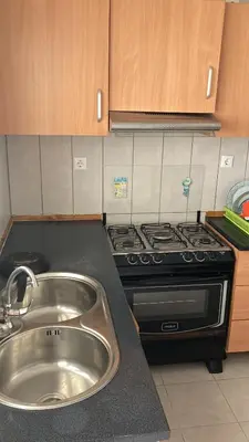 a kitchen with a sink and a stove at Prédio IFH Maio in Vila do Maio