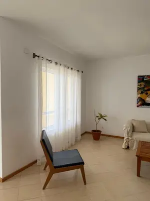 a living room with a chair and a couch at Mira Mar Condominium, Palmarejo Baixo in Praia