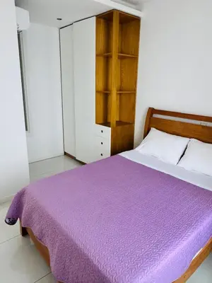 a bedroom with a purple blanket on a bed at Sweet Apartment Palmarejo - Marina Residence in Praia