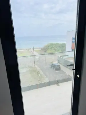 a view of a parking lot from a sliding glass door at Sweet Apartment Palmarejo - Marina Residence in Praia