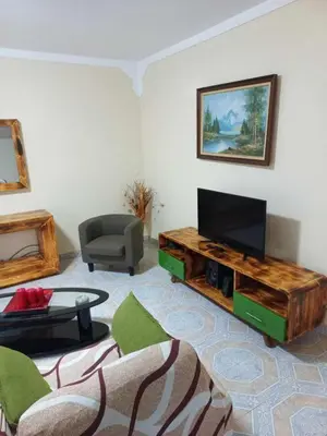 a living room with a couch and a television at Casatata in São Filipe