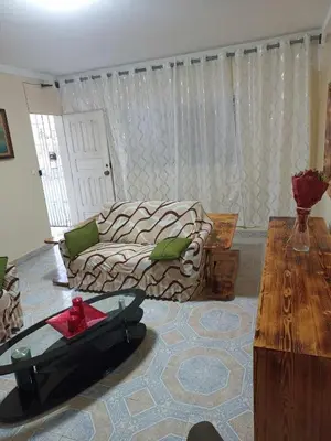 a living room with a couch and a table at Casatata in São Filipe