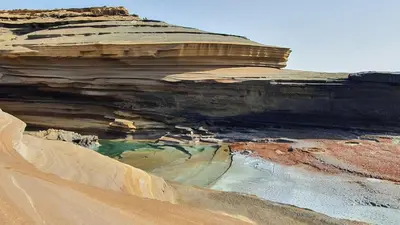 a rock formation in the desert with a pool of water at Residência Alto Saco, Ocean-view double room in Tarrafal