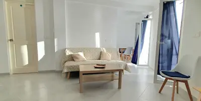 a living room with a couch and a table at Residência Alto Saco, Double room with private bathroom in Tarrafal