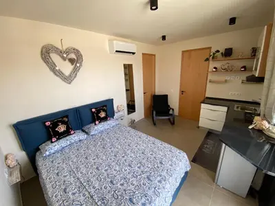 a bedroom with a blue bed with a heart sign on the wall at Crown Paradise Beach Lagoon Studio in Sal Rei