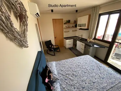 a bedroom with a bed and a desk in a room at Crown Paradise Beach Lagoon Studio in Sal Rei