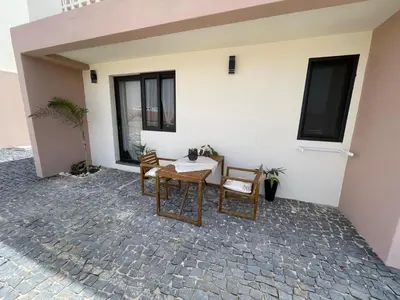 a patio with a table and chairs in front of a building at Crown Paradise Beach Lagoon Studio in Sal Rei