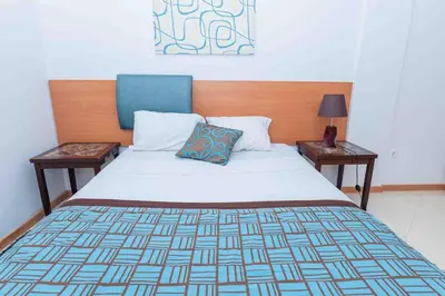 a bedroom with a bed with two nightstandiatesiatesiatesiatesiatesiatesiates at Chã de Areia Lounge Vista Mar - Apartamento T2 in Praia