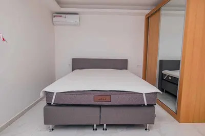 a bed in a room with a mattress on the floor at Otro Residence in Praia