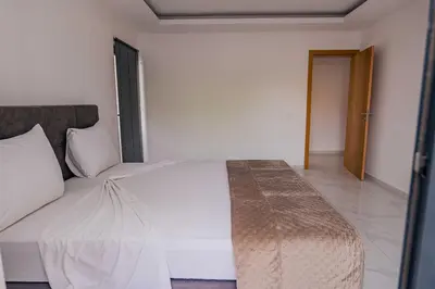 a bedroom with a white bed in a room at Otro Residence in Praia