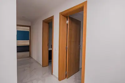 a corridor with wooden doors in a room at Otro Residence in Praia