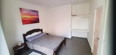 a bedroom with a bed and a painting on the wall at Refugio Cesaria in Tarrafal