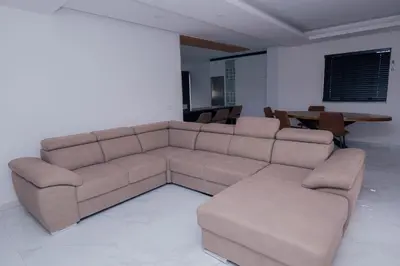 a living room with a brown couch and a table at Otro Residence in Praia