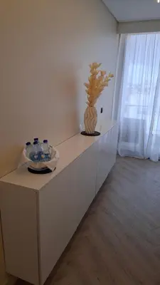 a white counter with a vase on top of it at Serenity in Praia
