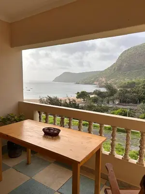 a table on a balcony with a view of the ocean at Sun & Sea Tarrafal in Tarrafal