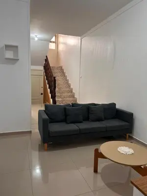 a living room with a couch and a staircase at Sun & Sea Tarrafal in Tarrafal