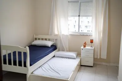 a bedroom with two bunk beds and a window at T2 com escritório - Férias Teletrabalho in Praia