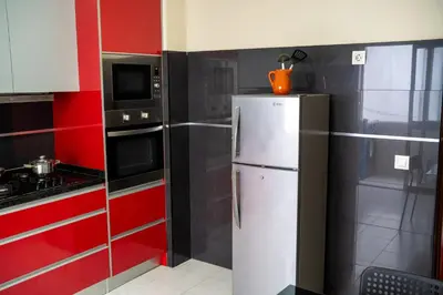 a kitchen with a refrigerator and a microwave at T2 com escritório - Férias Teletrabalho in Praia