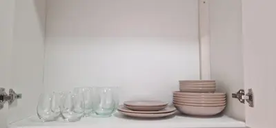 a shelf with glasses and plates and bowls at Sal Casa VILLAGE in Santa Maria