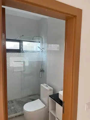a bathroom with a toilet and a glass shower at Lucy aparte in Praia