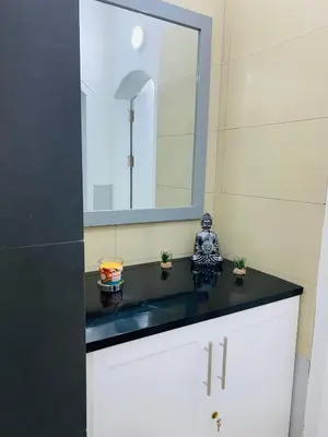 a bathroom with a black counter and a mirror at Large 1 bedroom Apt with sofa bed in Santa Maria