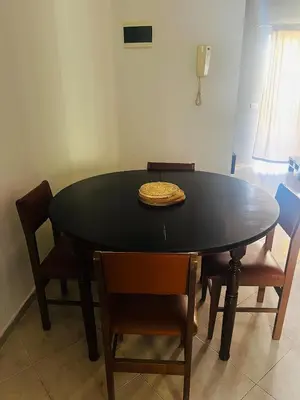 a dining room table with chairs and a bowl on top at Santa Maria Central Stay in Santa Maria