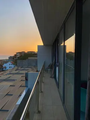a balcony of a building with the sunset in the background at Nice Duplex in Praia