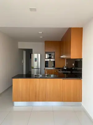 a kitchen with wooden cabinets and a stainless steel refrigerator at Nice Duplex in Praia