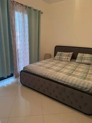 a bed sitting in a room with a window at Penthouse Ocean View in Mindelo