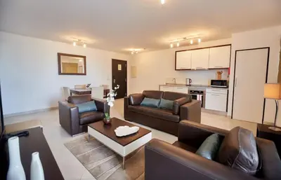a living room with two couches and a kitchen at Lux 1BR S Maria 90 Day Stay in Santa Maria