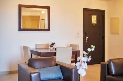 a living room with a table and chairs and a mirror at Lux 1BR S Maria 90 Day Stay in Santa Maria