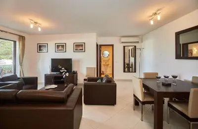 a living room with a couch and a dining room at Lux 1BR S Maria 90 Day Stay in Santa Maria