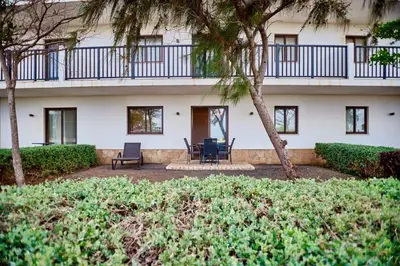 a building with two chairs and a patio at Lux 1BR S Maria 90 Day Stay in Santa Maria