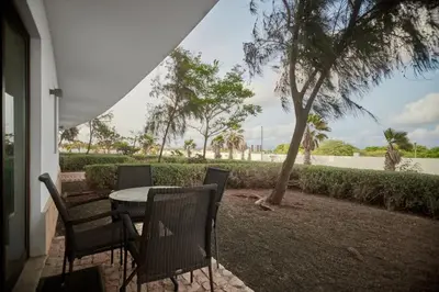 a patio with a table and chairs and trees at Lux 1BR S Maria 90 Day Stay in Santa Maria