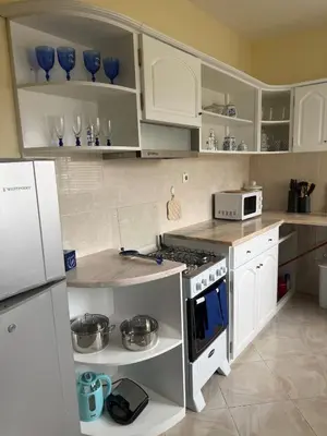 a kitchen with white cabinets and a stove top oven at Affordable Beach Town Apartment in Santa Maria